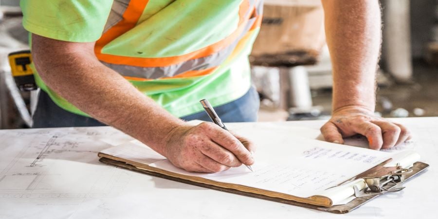 man filling out construction paperwork